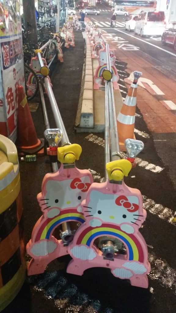 Kawaii Hello Kitty road safety barriers block off a construction zone outside Shinjuku station in Tokyo